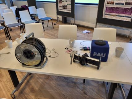 Behind the scenes: cables, mics, and the coffee that keeps it all running. Photo: A. Dakkouri-Baldauf