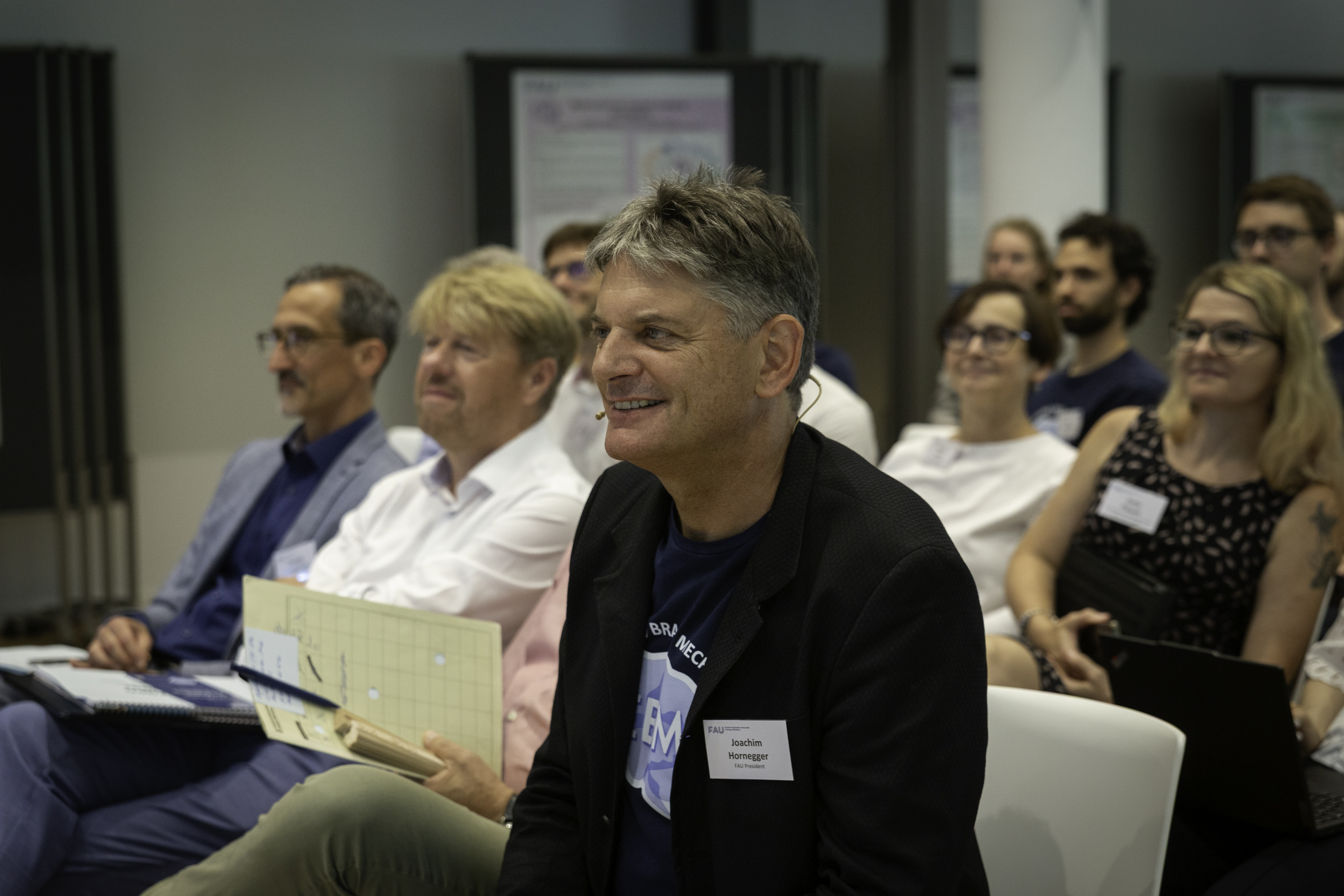 FAU President Joachim Hornegger, right there in the audience, showing his support for EBM — just before taking his turn at the podium. Photo: M. Gräve, J. Gonzalez / MMZ (FAU)